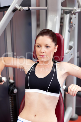 athletic woman using a bench press