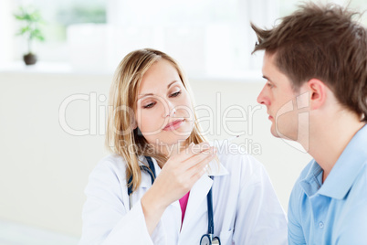 female doctor looking at patient's temperature