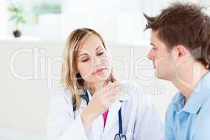 female doctor looking at patient's temperature