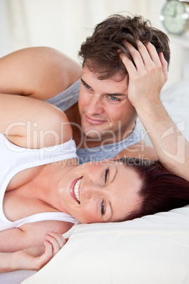 woman and boyfriend lying on the bed