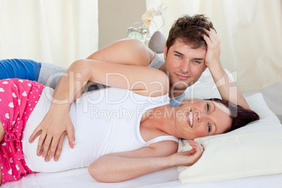 future parents lying on the bed