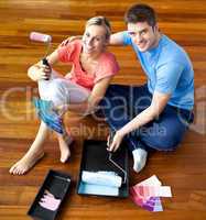 Young couple sitting on floor smiling