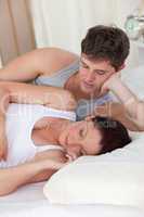 woman lying on the bed with her boyfriend