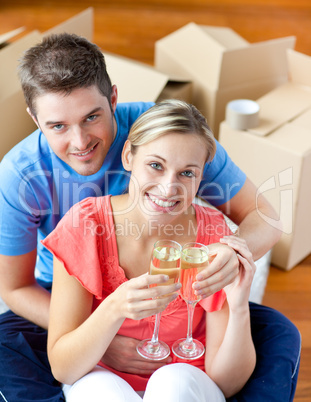 cheerful couple celebrating their new house