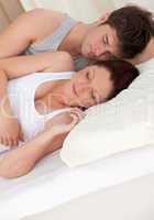 young future parents sleeping on the bed