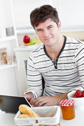 man with laptop and during his breakfast