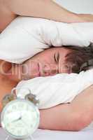 male adult stressed by his alarm clock
