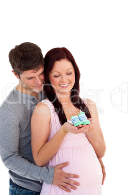 parents looking at baby shoes