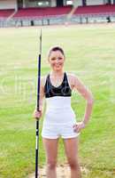 joyful sporty woman holding a javelin