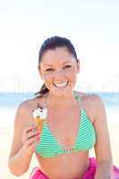 woman eating ice-cream on the beach