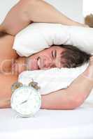 man woken-up by his alarm clock