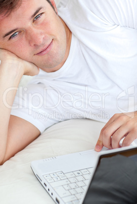 man writing on his laptop