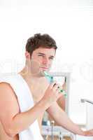 man brushing his tooth