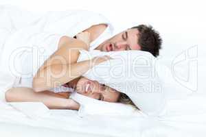 woman in bed with her boyfriend snoring