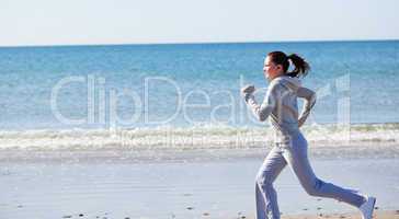 Attractive woman runnng on the beach