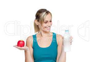 woman holding water and apple