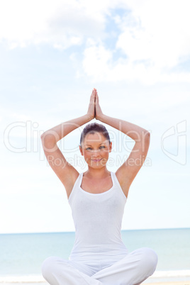 woman doing yoga on beach