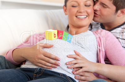 man kissing his pregnant wife