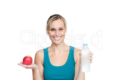 woman holding an apple and a bottle of water