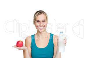 woman holding an apple and a bottle of water