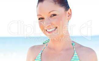 woman smiling at the camera on the beach