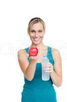 woman holding bottle of water and apple