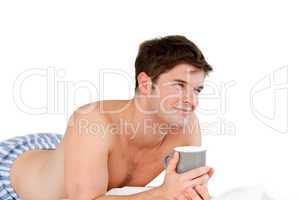 smiling man holding a cup of coffee