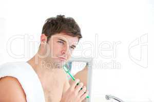 male brushing his tooth