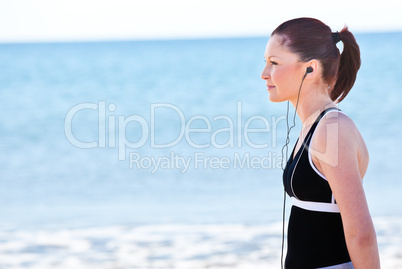 woman listening music on the beach
