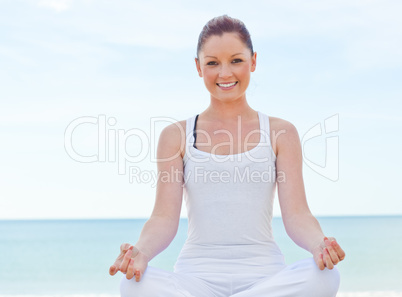 woman doing yoga over sea background