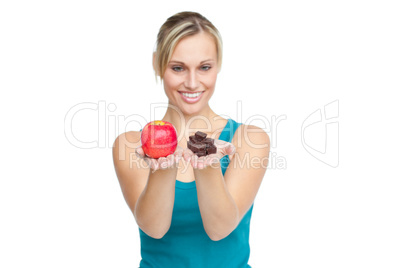 woman holding an apple and chocolates