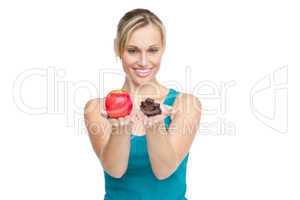 woman holding an apple and chocolates