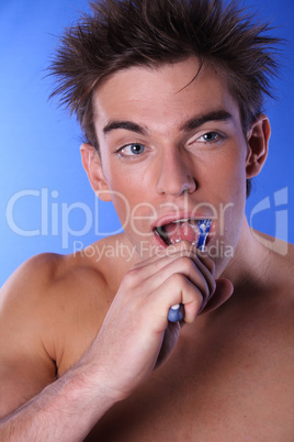 Young man brushing teeth