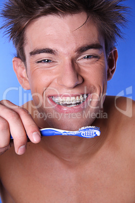 Young man brushing teeth