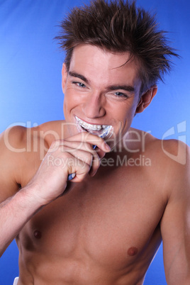 Young man brushing teeth