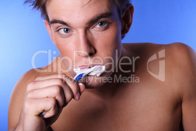 Young man brushing teeth