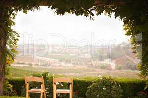 Vine Covered Patio and Chairs Overlooking the Country