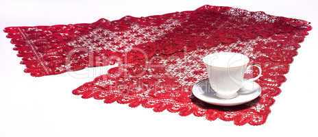white cup on red doily