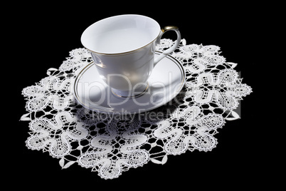 White cup on small doily