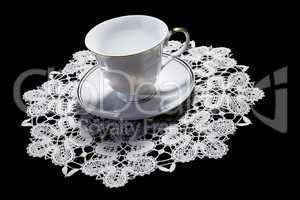 White cup on small doily