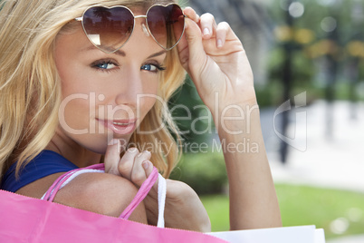 Beautiful Happy Woman With Pink and White Shopping Bags