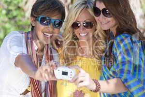 Three Women Friends Taking Pictures of Themselves on Digital Cam