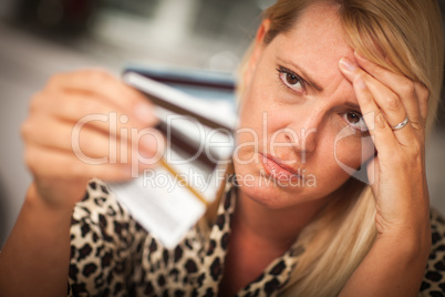 Upset Woman Glaring At Her Many Credit Cards