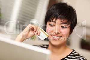 Smiling Multiethnic Woman Holding Credit Card Using Laptop