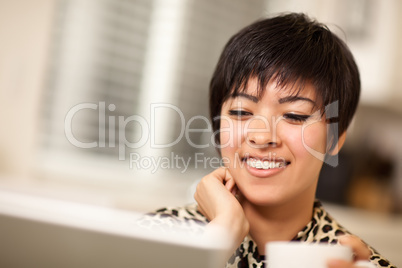 Pretty Smiling Multiethnic Woman Using Laptop