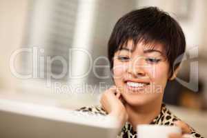 Pretty Smiling Multiethnic Woman Using Laptop