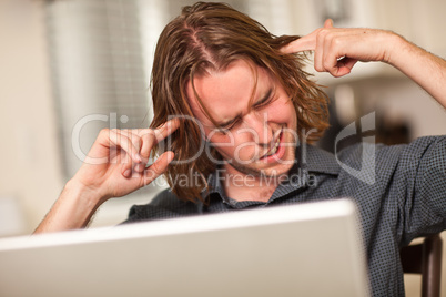 Young Man Getting Loopy While Using Laptop Computer