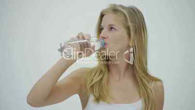 HD1080p25 Young woman with water bottle in hand against white background