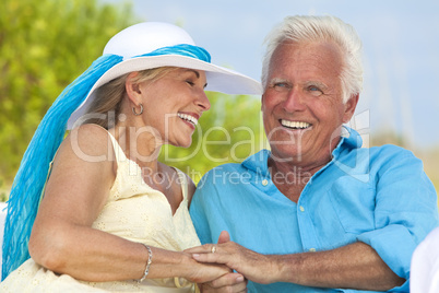 Happy Senior Couple Holding Hands & Laughing at the Beach