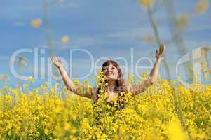 Happy girl in flower meadow.
